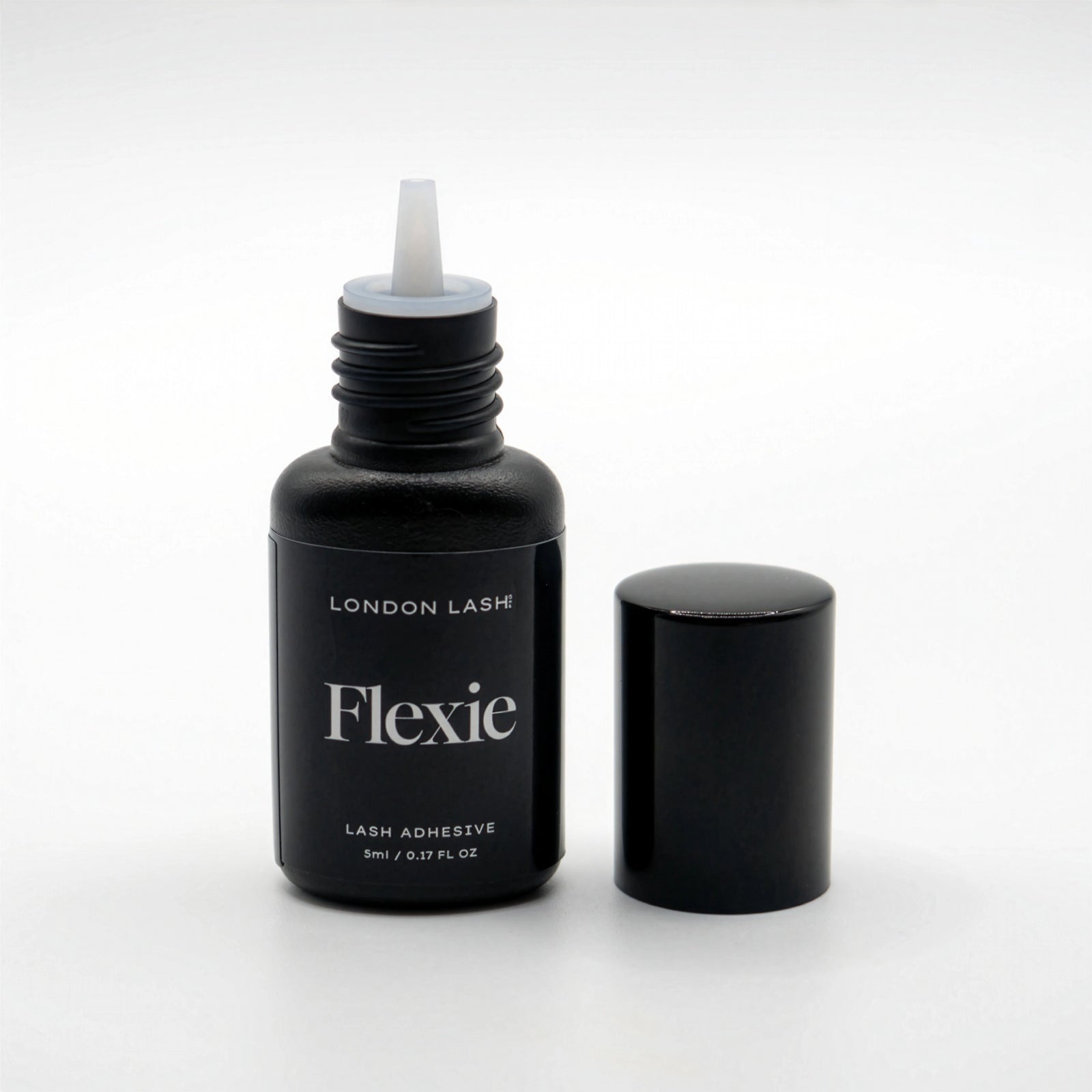 Bottle of London Lash Flexie lash adhesive on a white background