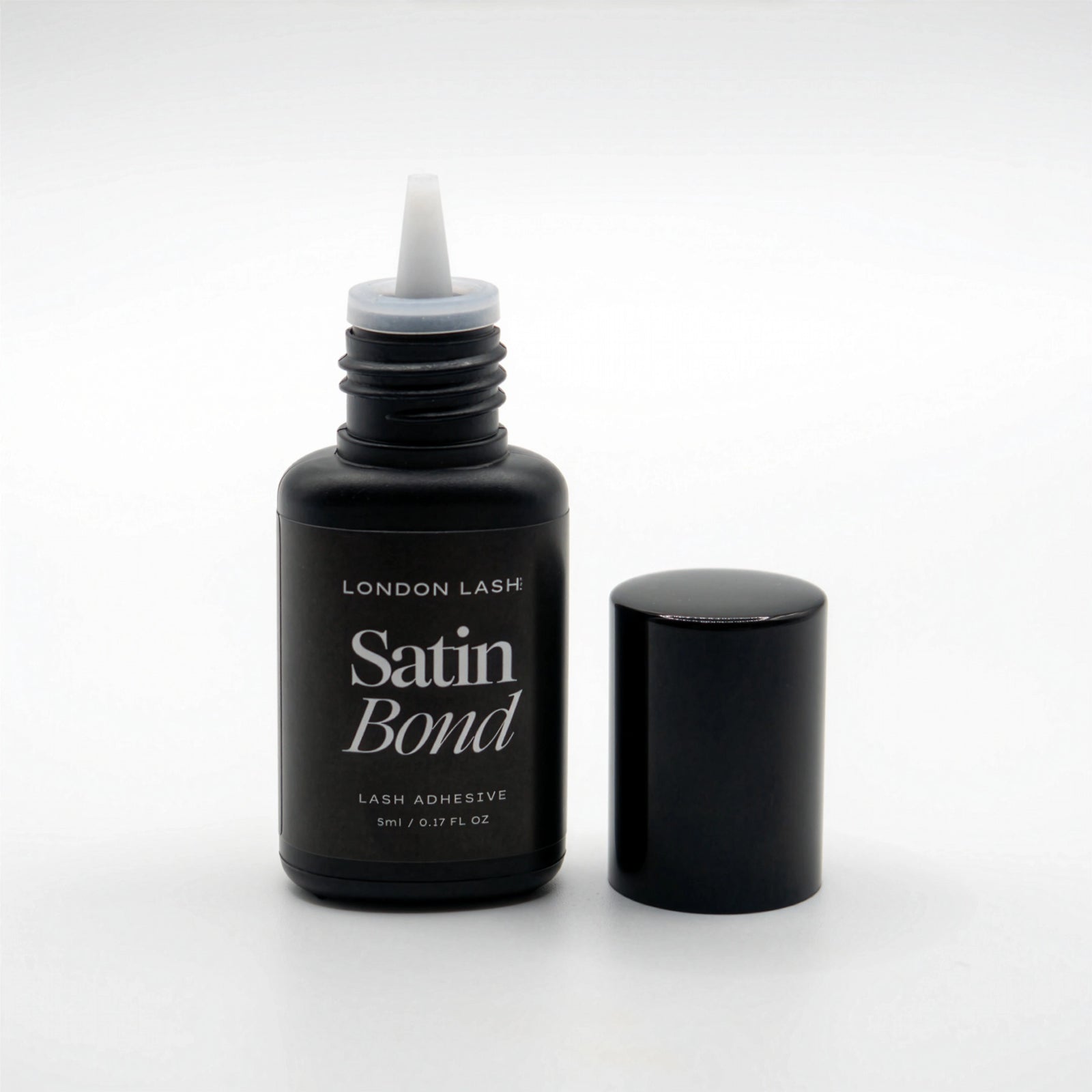 Bottle of London Lash Satin Bond lash adhesive on a white background
