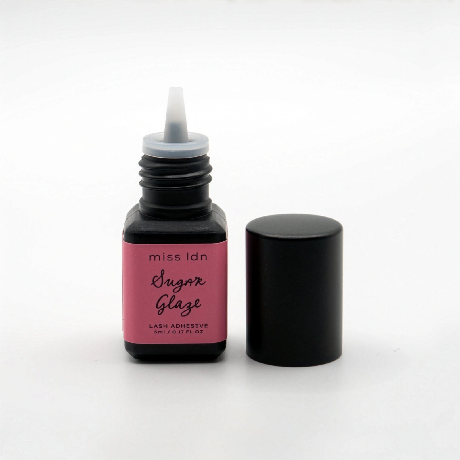 Bottle of miss ldn Sugar Glaze lash adhesive on a white background