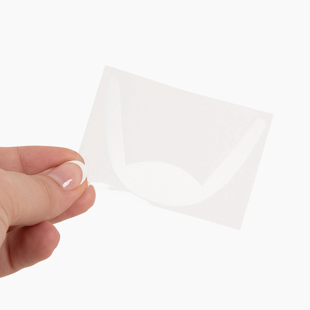 Hand holding London Lash Fix Pads against a white background