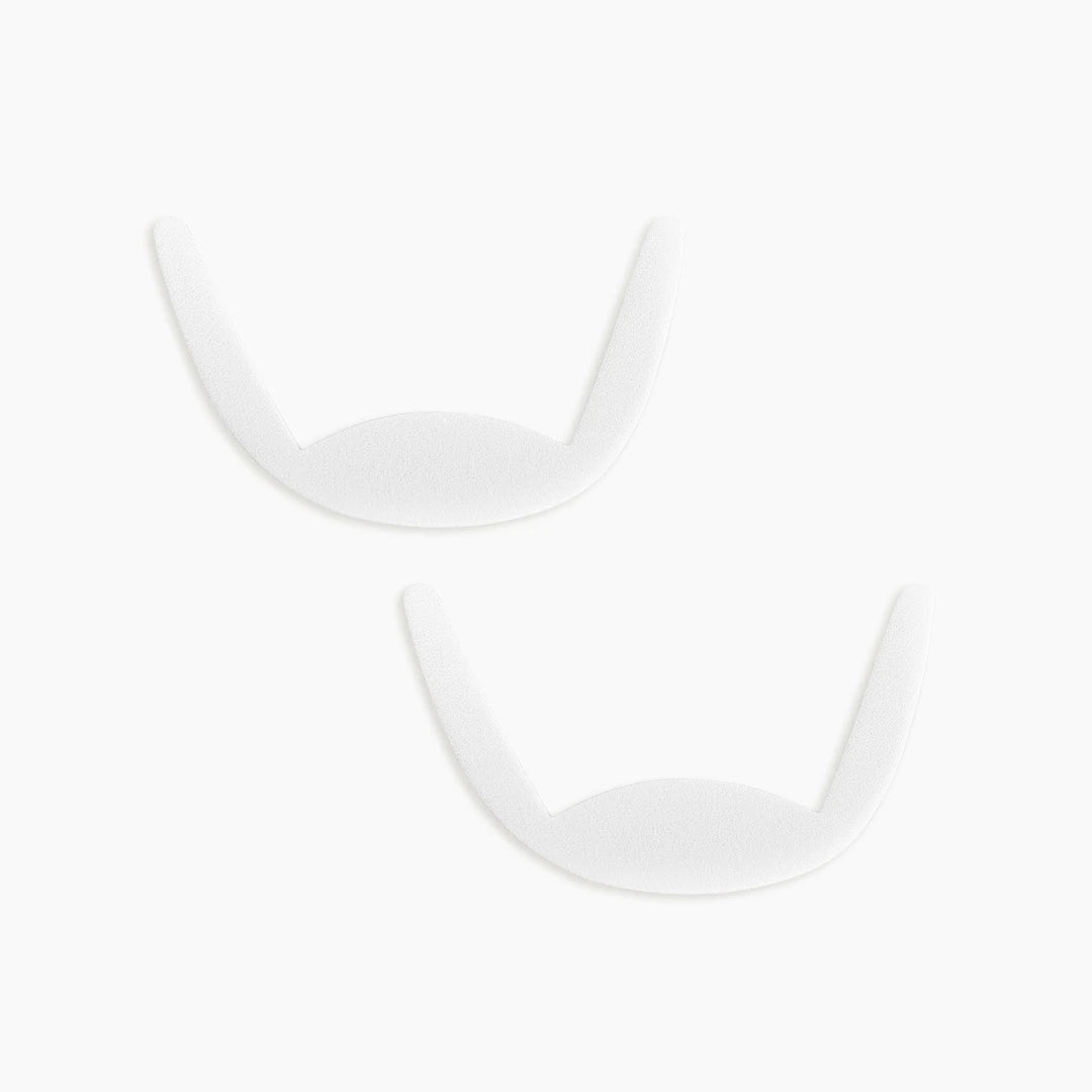 Two eye pads on white background to showcase the shape