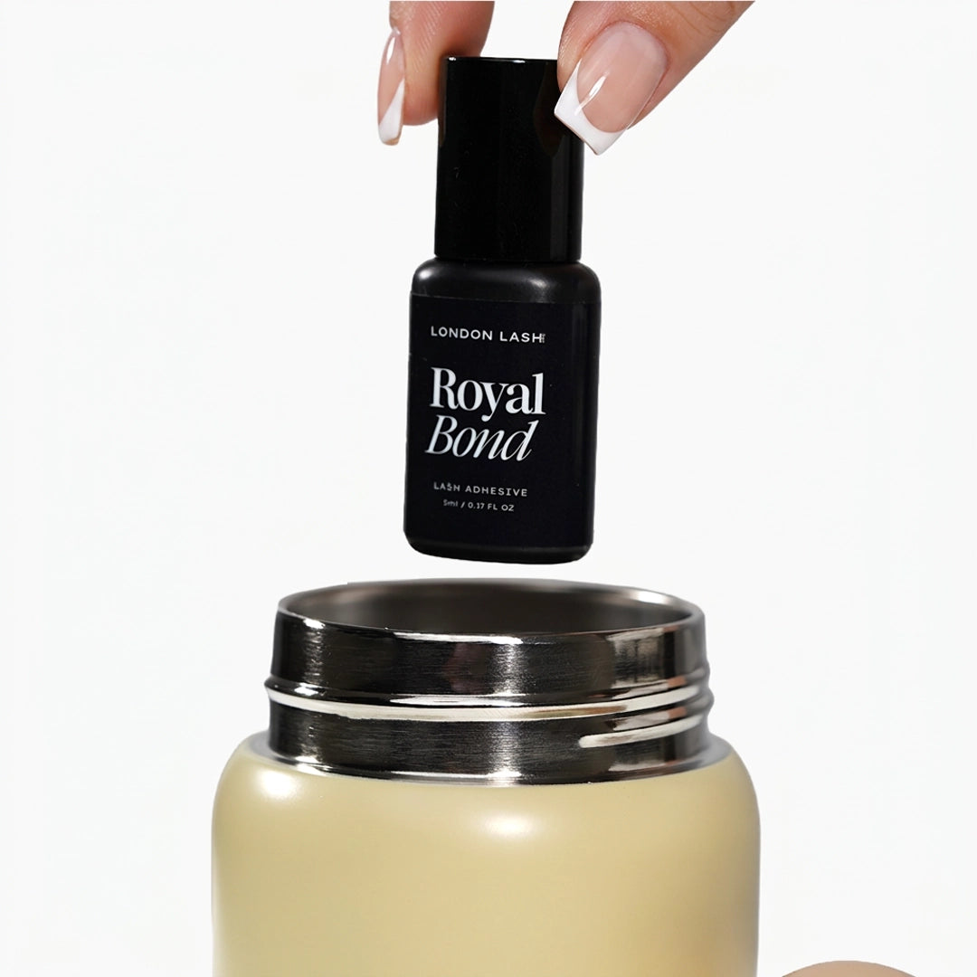 Hand holding Royal Bond Adhesive on top of an open beige airtight container on a white background.
