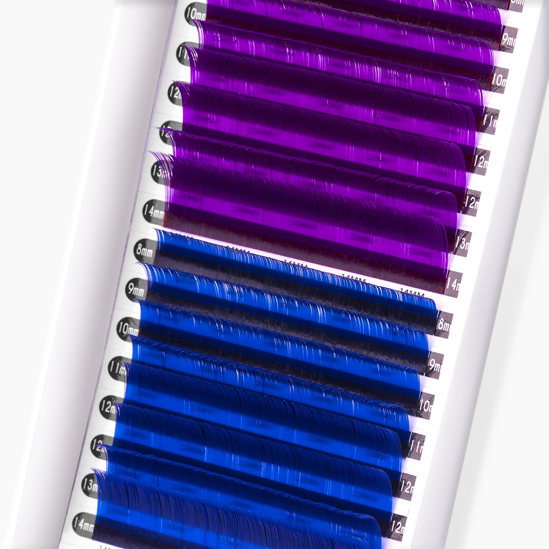 Close up of violet and blue coloured lash extensions strip on white background