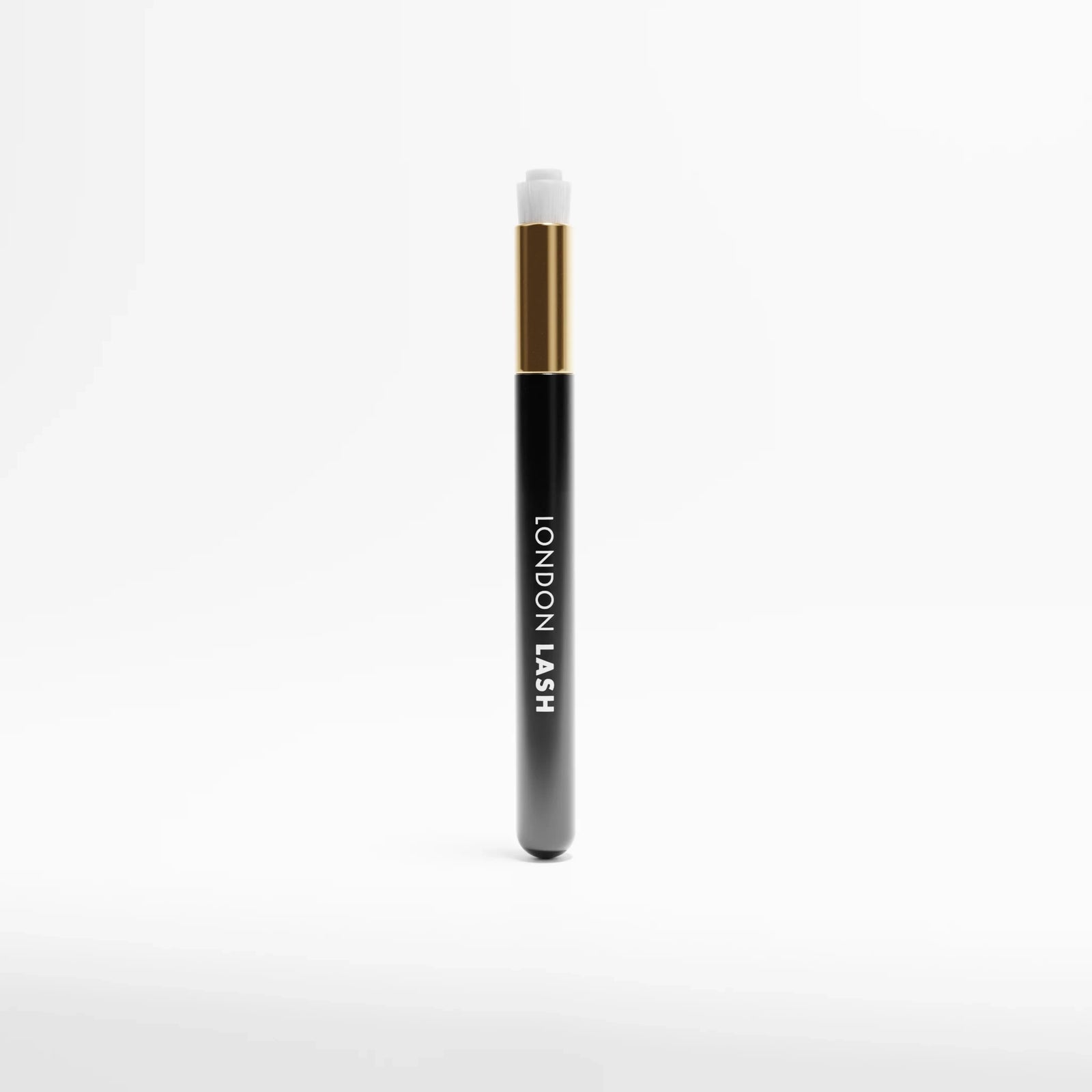 Five black and gold Lash & Brow Cleansing Brush labeled 'London Lash' on a white background