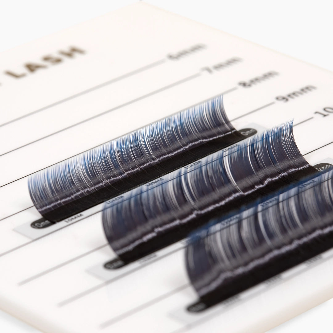 Three strips of blue ombre eyelash extensions on a palette