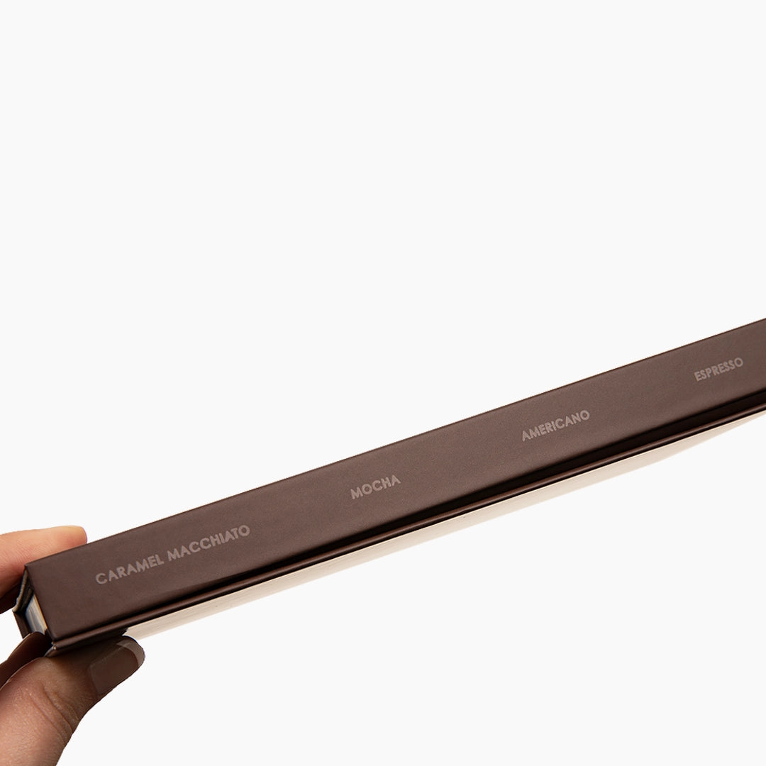 Hand holding the London Lash Brown Collection lash tray with the four lash shade names written on the tray
