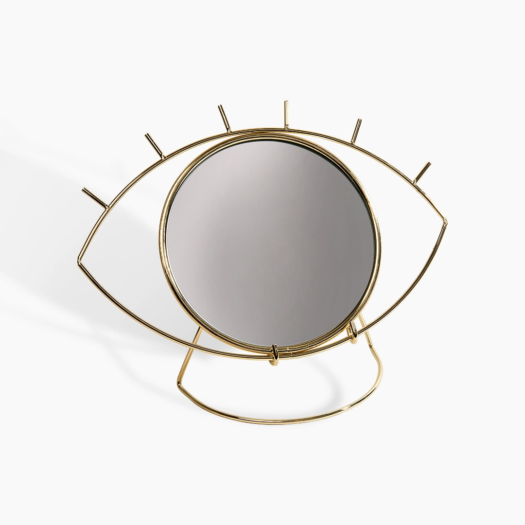 London Lash mirror with eye-shaped gold frame on a white background