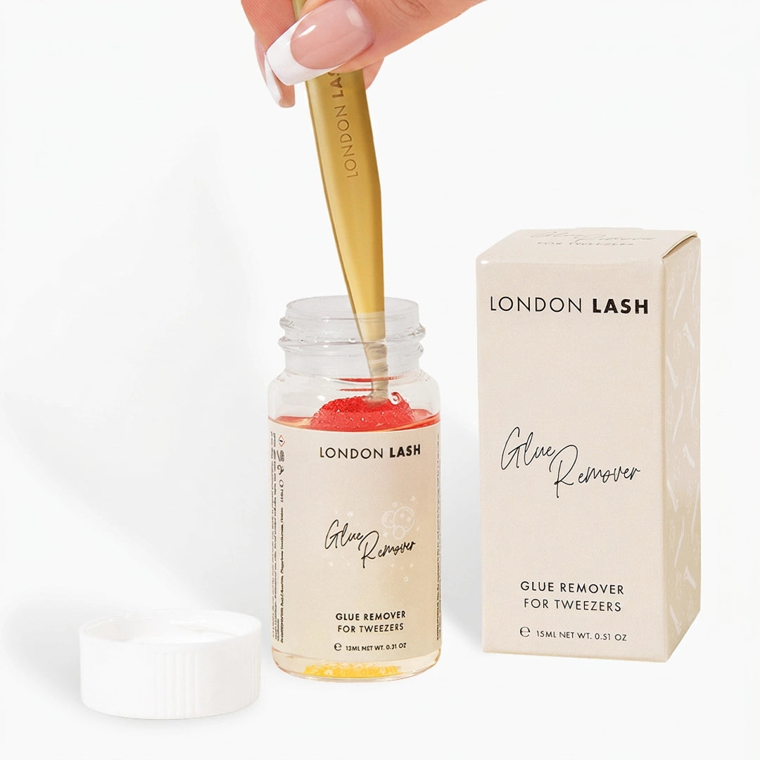 Hand dipping tweezers into London Lash Glue Remover