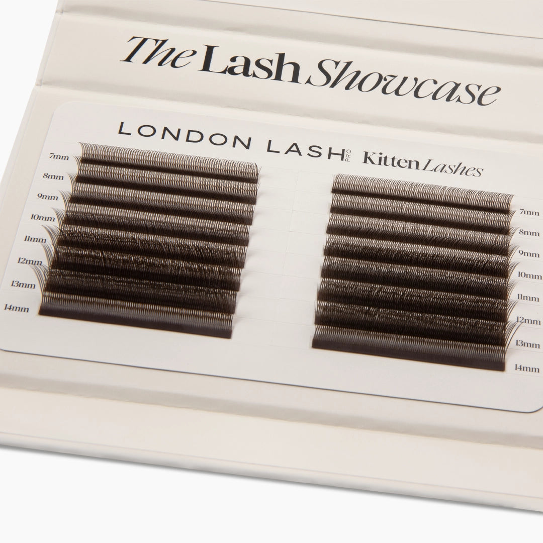 Overhead close-up of two neat columns of brown Kitten Lash extension strips with millimeter length labels from 7mm to 14mm.