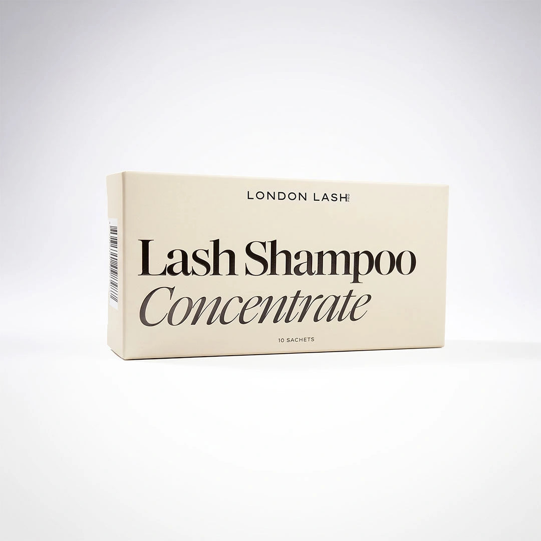 A cream-colored rectangular box of London Lash Lash Shampoo Concentrate, featuring black text, set against a clean white background.