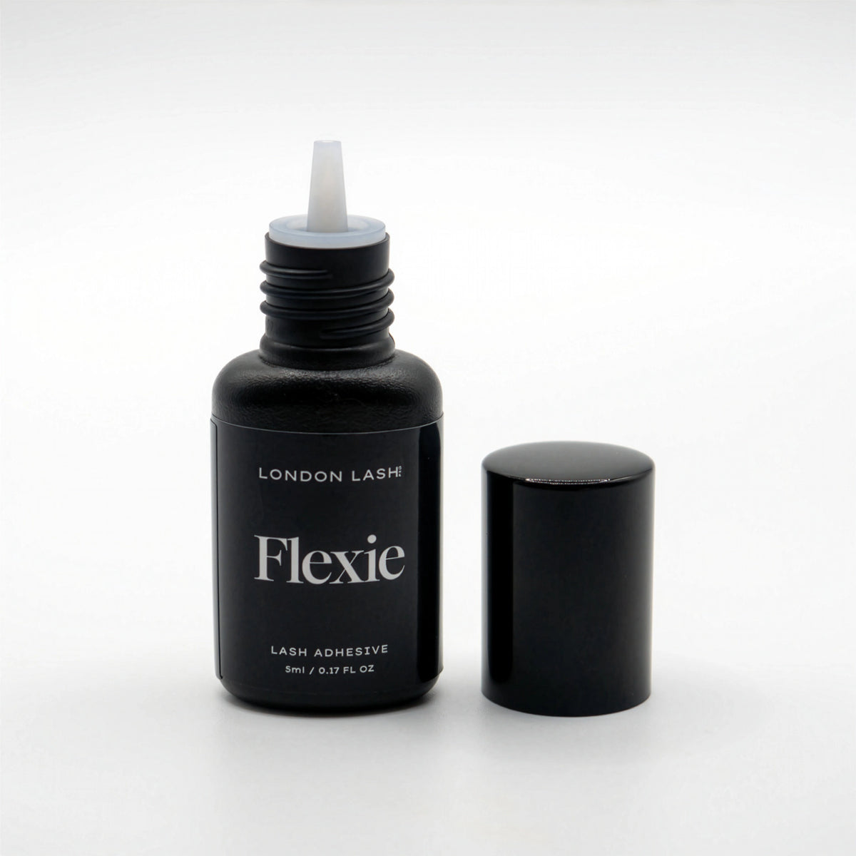 Opened bottle of London Lash Flexie lash adhesive on a white background