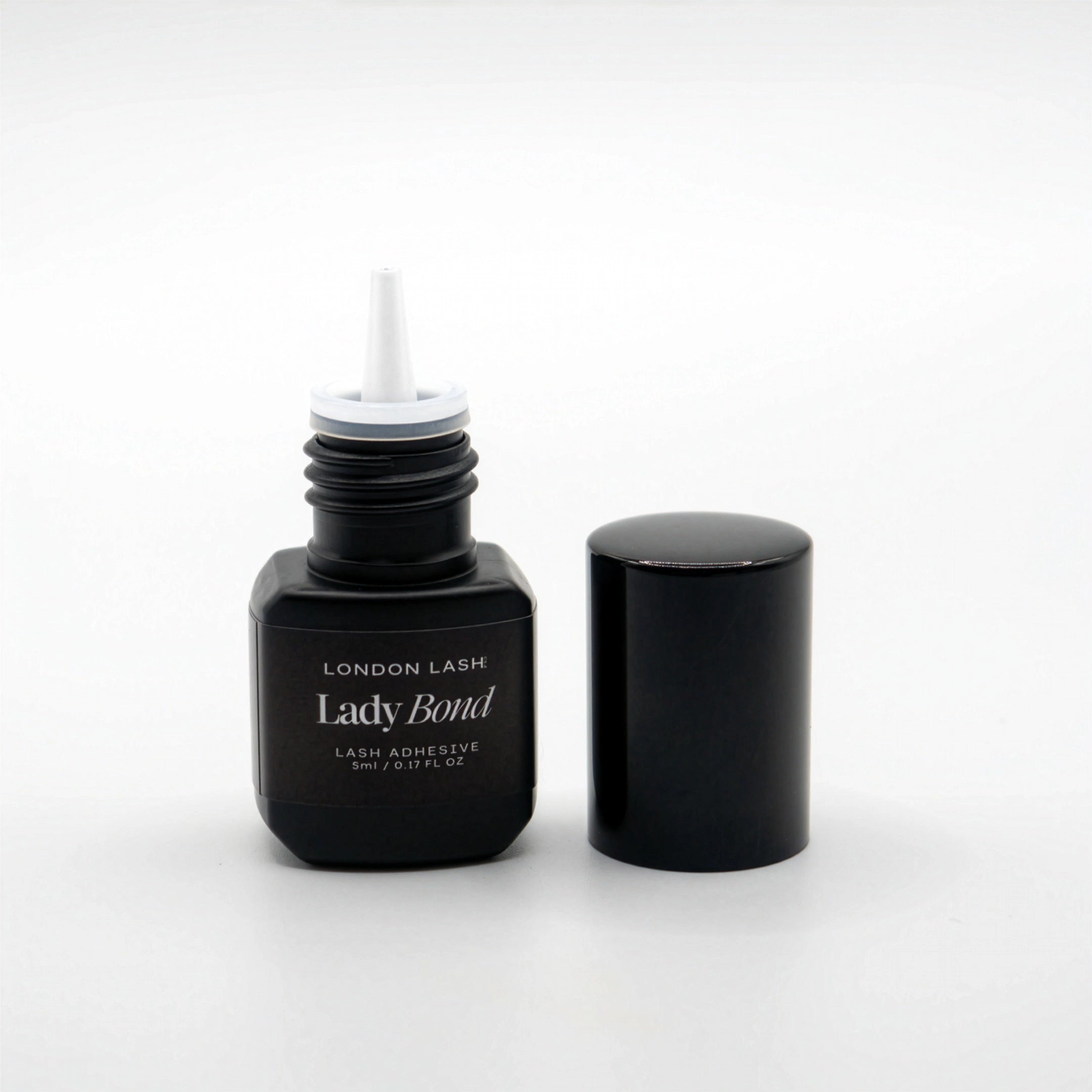Opened bottle of London Lash Lady Bond lash adhesive on a white background