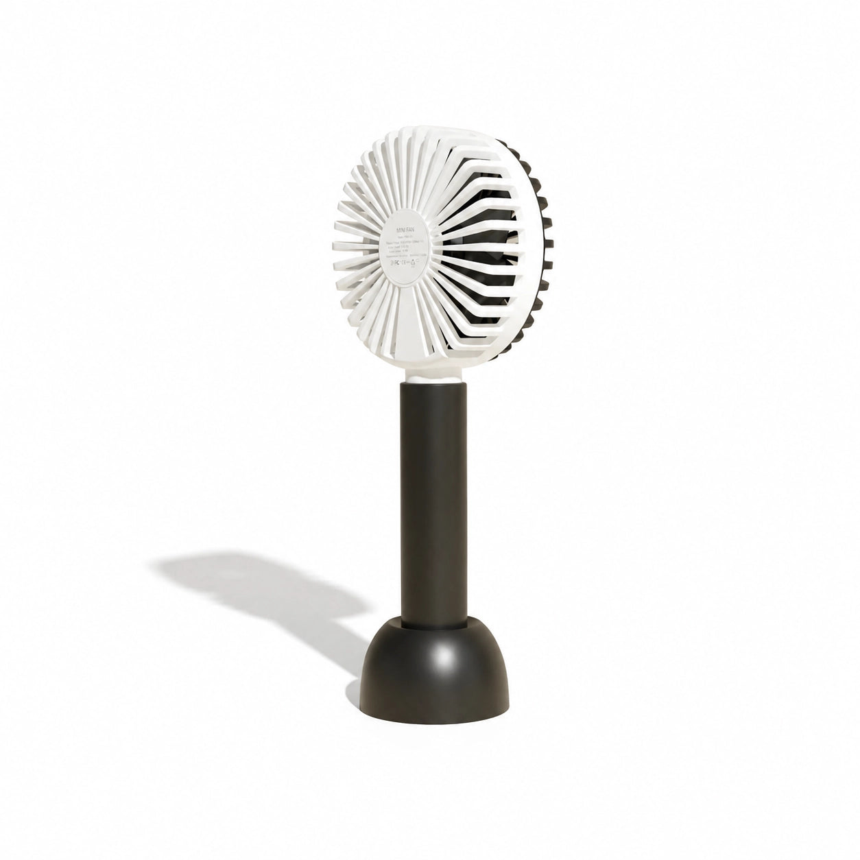 Small portable fan with white blades and black base on a white background