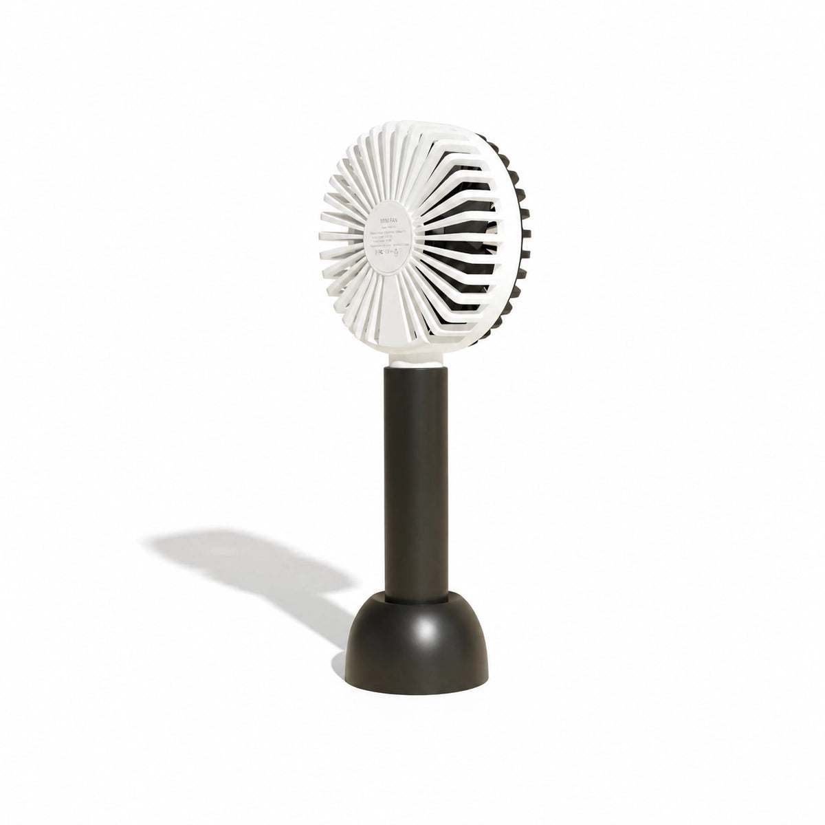 Small portable fan with white blades and black base on a white background