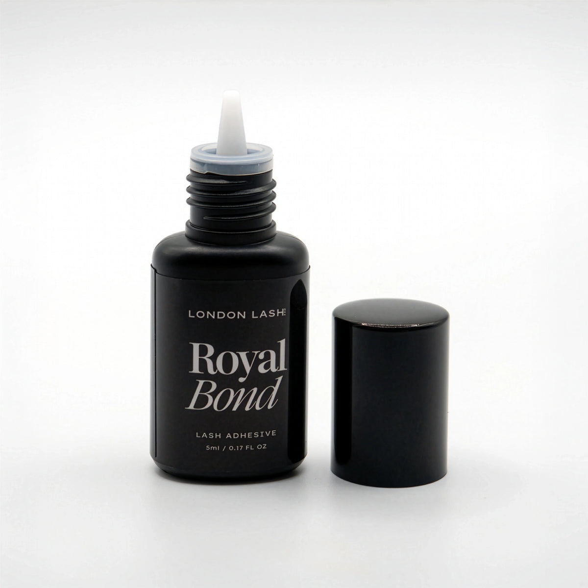 Opened bottle of London Lash Royal Bond lash adhesive on a white background