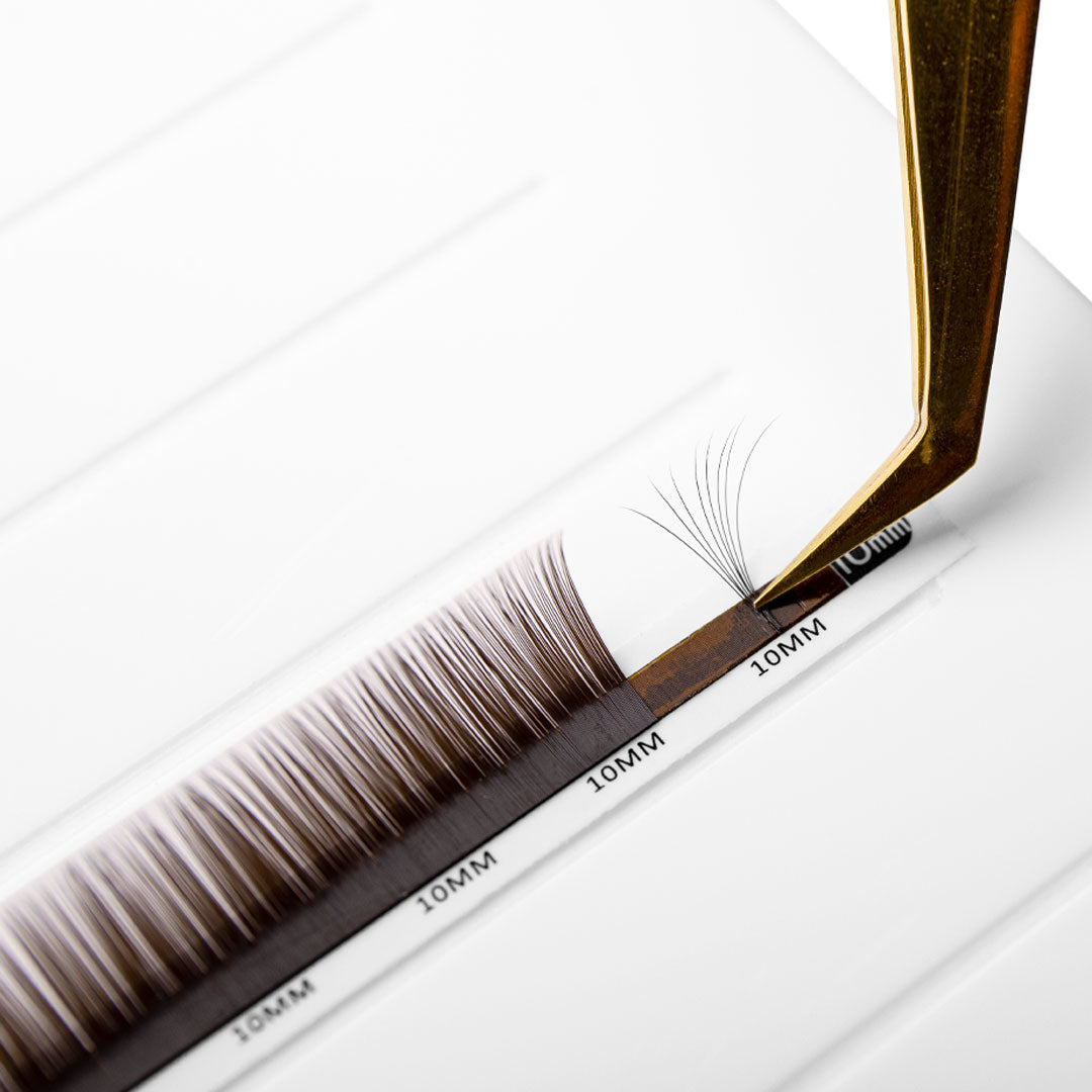 brown eyelash extensions in 0.03 being fanned with fine tip volume tweezers