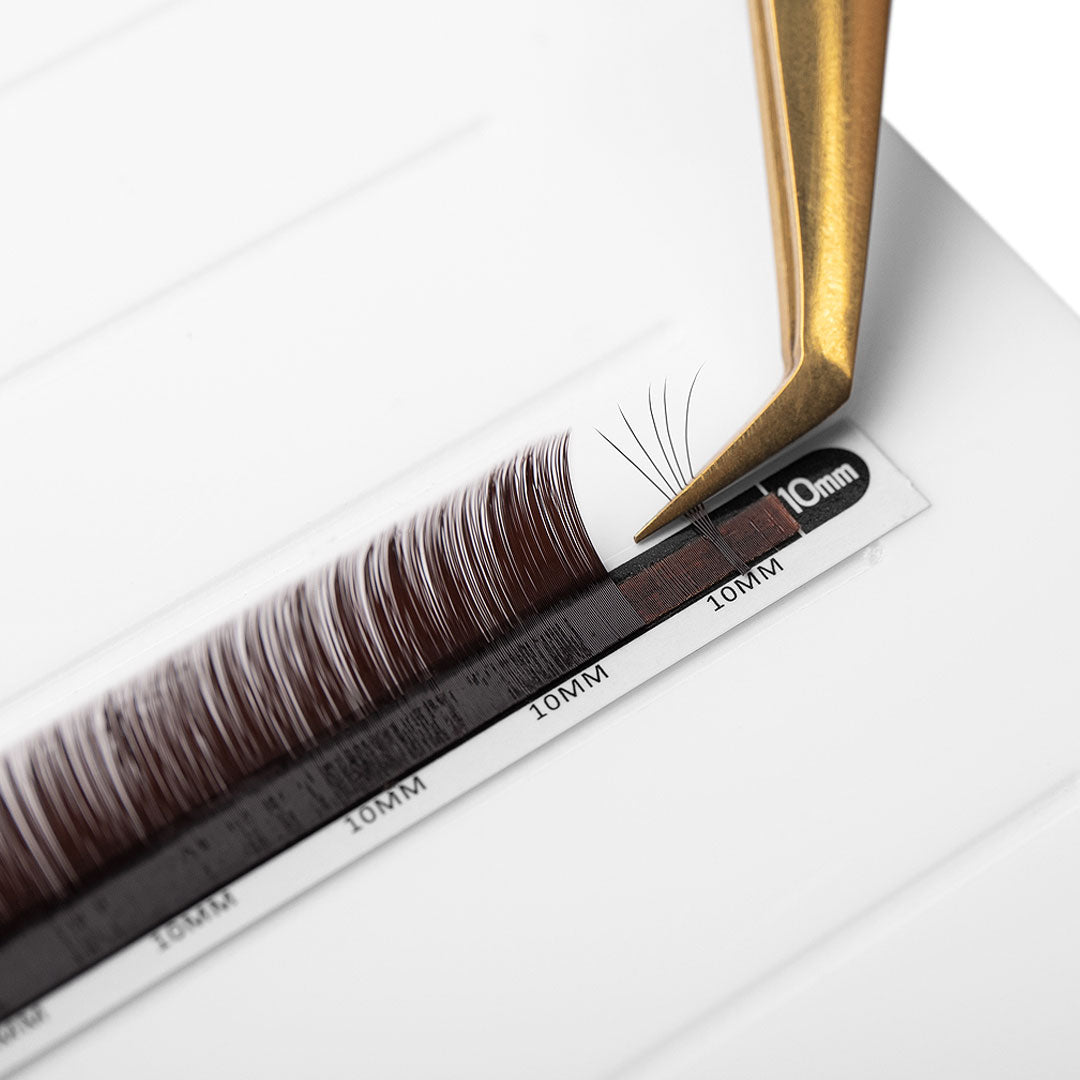 brown eyelash extensions in 0.07 being fanned with fine tip volume tweezers