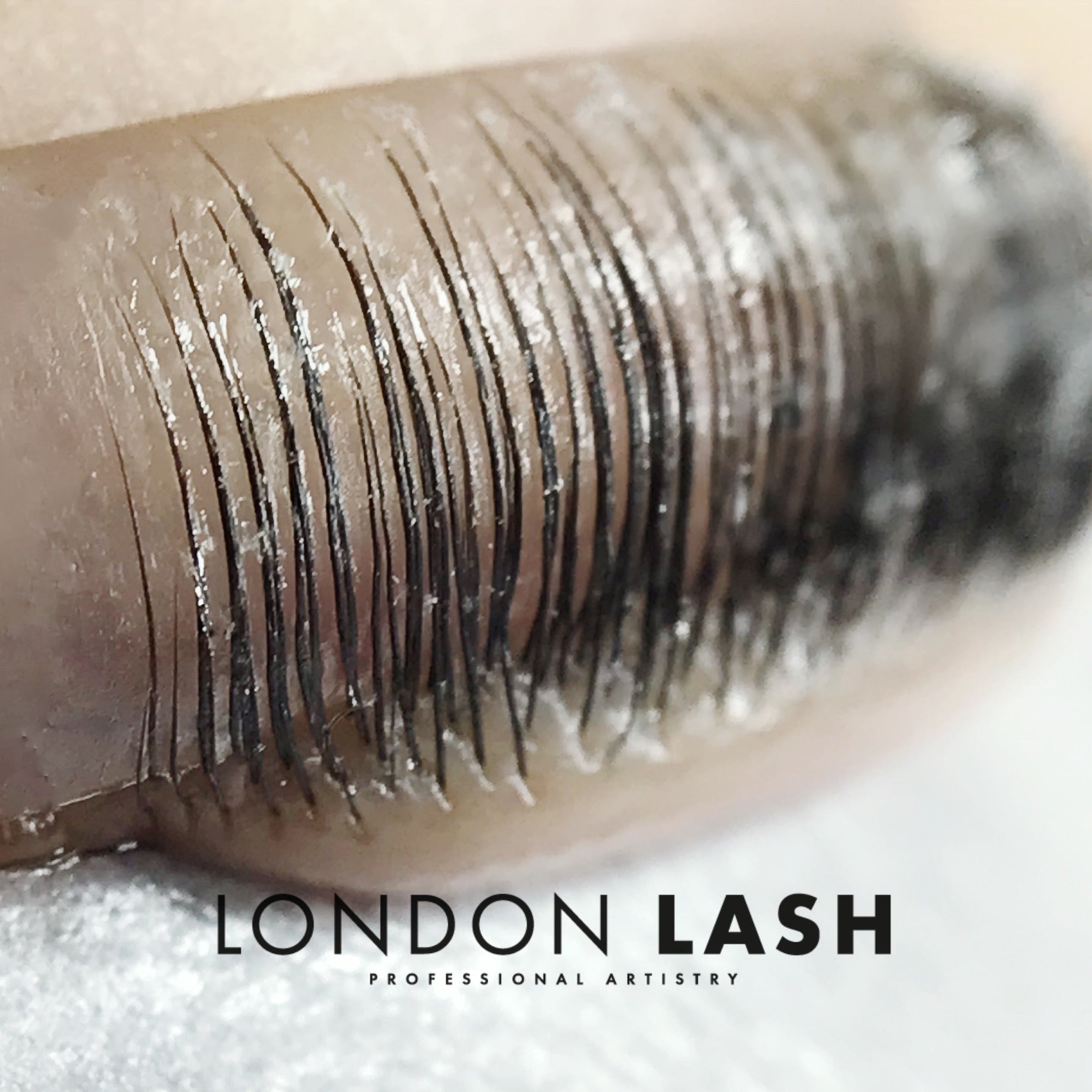 a close up of natural lashes lifted onto a silicone shield during a lash filler treatment